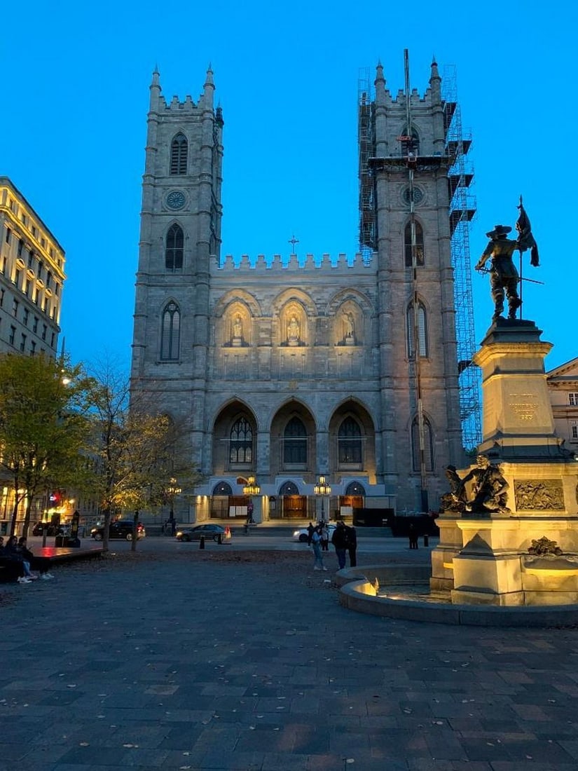Notre-Dame at Dusk: Notre-Dame at Dusk A captivating photograph of the Notre-Dame Basilica of Montreal bathed in the golden glow of twilight, just before sunset. The soft evening light enhances the intricate Gothic