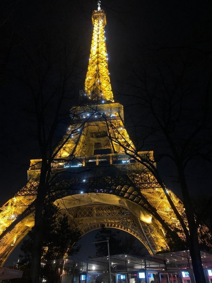 Parisian Glow: Parisian Glow Bring the romance and splendor of Paris into your home with this exclusive hand-painted canvas opportunity. The photograph captures the Eiffel Tower illuminated against the night sky,