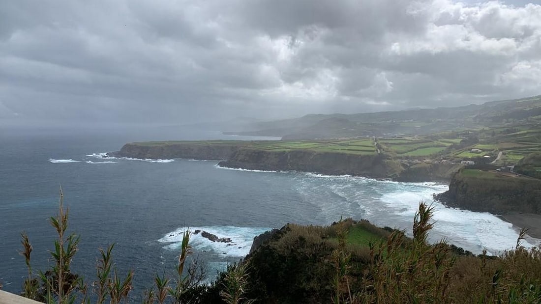 Misty Coastal Hills: Misty Coastal Hills Capture the serene beauty of a coastal hillside with this exclusive hand-painted canvas opportunity. The photograph showcases rolling hills dotted with houses and cultivated plots 