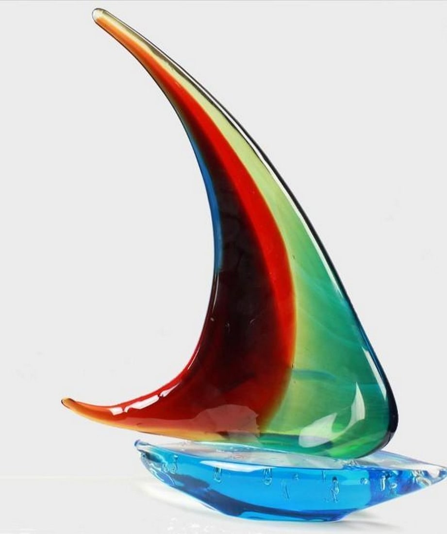 Winds of Colour: Winds of Colour Bright and full of character, this Murano glass sailboat features bold sails in red, yellow, and green - capturing the spirit of freedom and adventure. Hand-blown with artistic