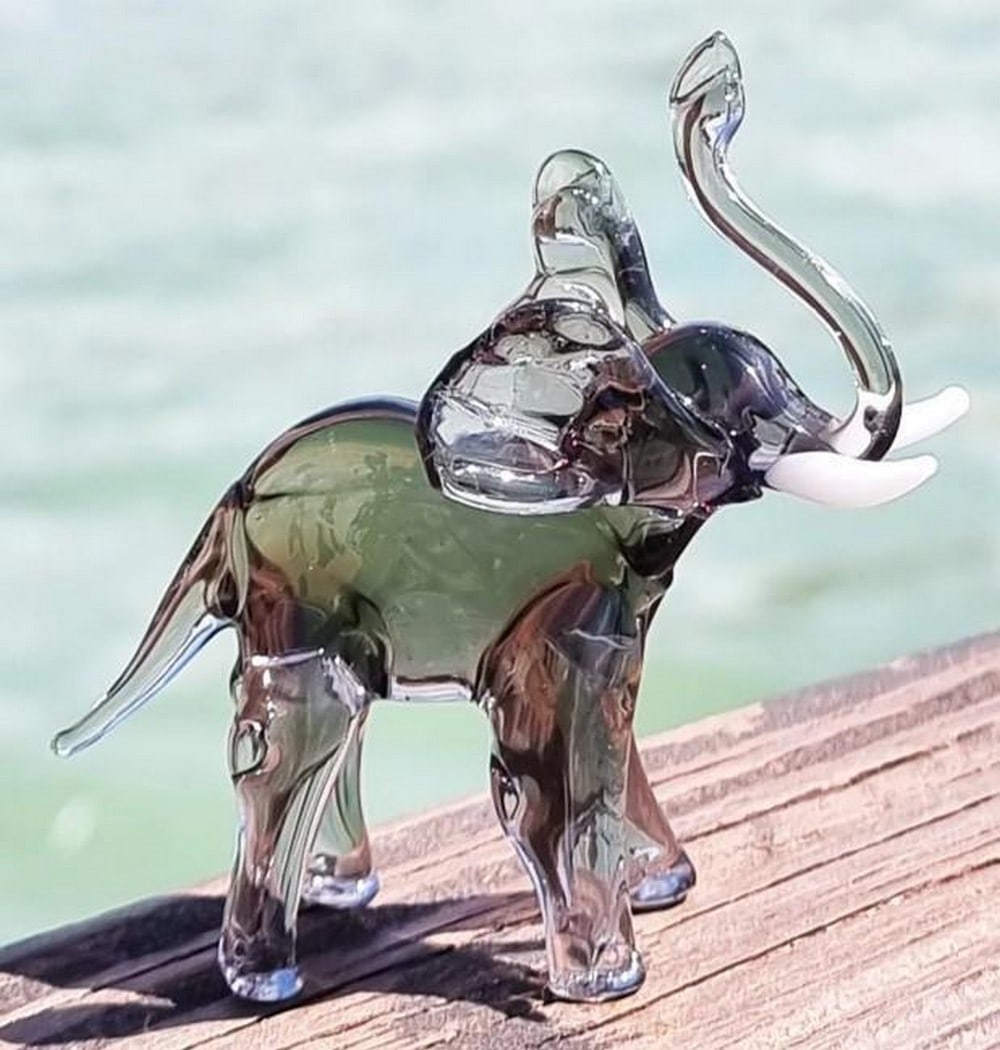 Smoked Glass Elephant: Smoked Glass Elephant Refined and majestic, this Murano glass elephant is sculpted in smoky translucent tones that highlight its graceful form and powerful presence. Hand-blown by skilled artisans,