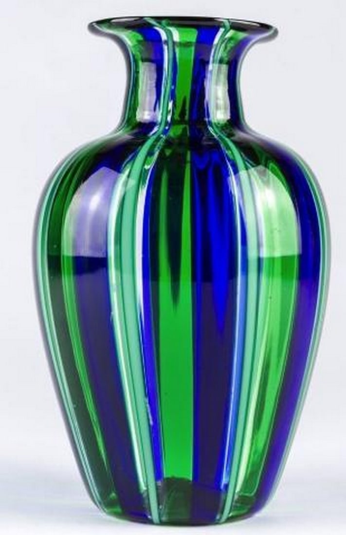 Blue and Green Cannes Filigree Murano Glass Vase: Blue and Green Cannes Filigree Murano Glass Vase Inspired by the elegance of the French Riviera, this vase is a striking display of Murano glass mastery. Featuring delicate vertical filigree stripes i