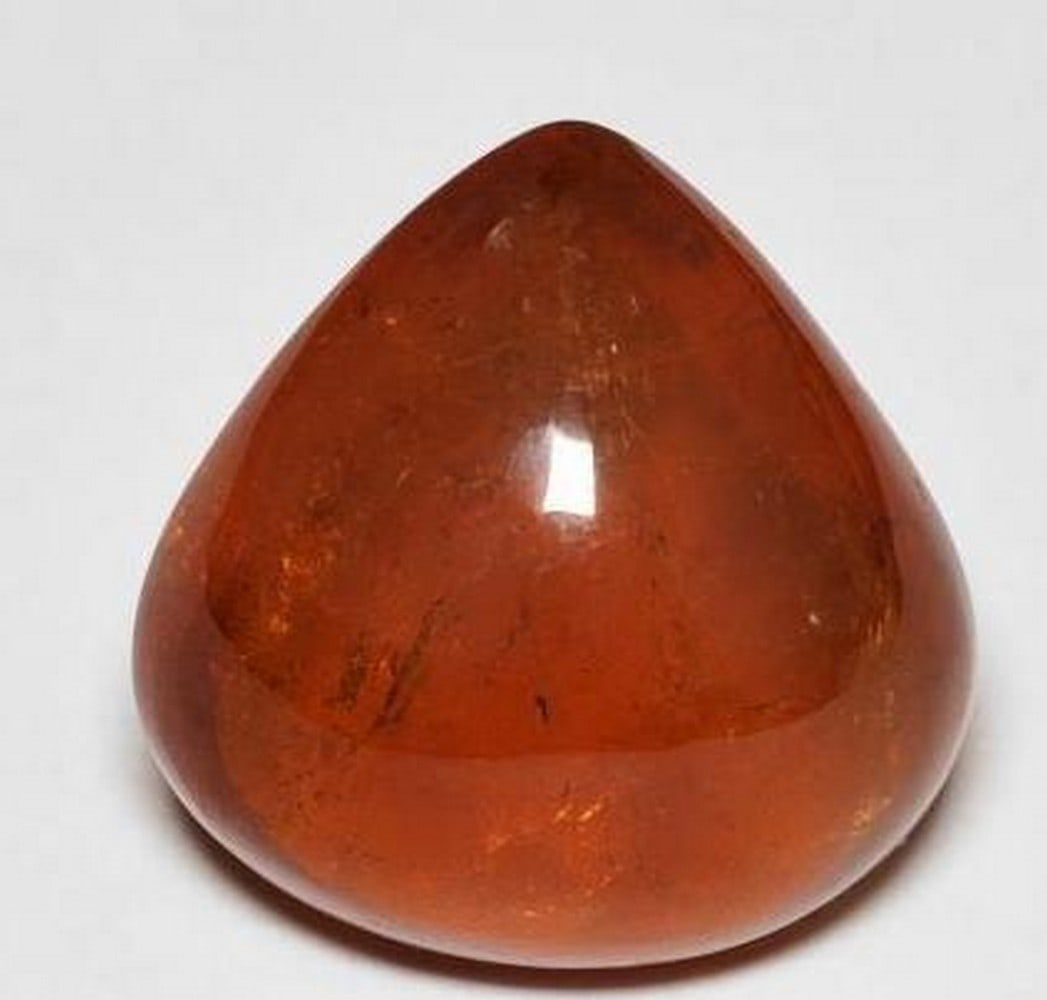 Fiery Reddish-Orange Spessartite Garnet: Fiery Reddish-Orange Spessartite Garnet Add a burst of vivid color to your collection with this captivating Spessartite Garnet. Expertly shaped into a smooth pear cabochon, this loose gemstone