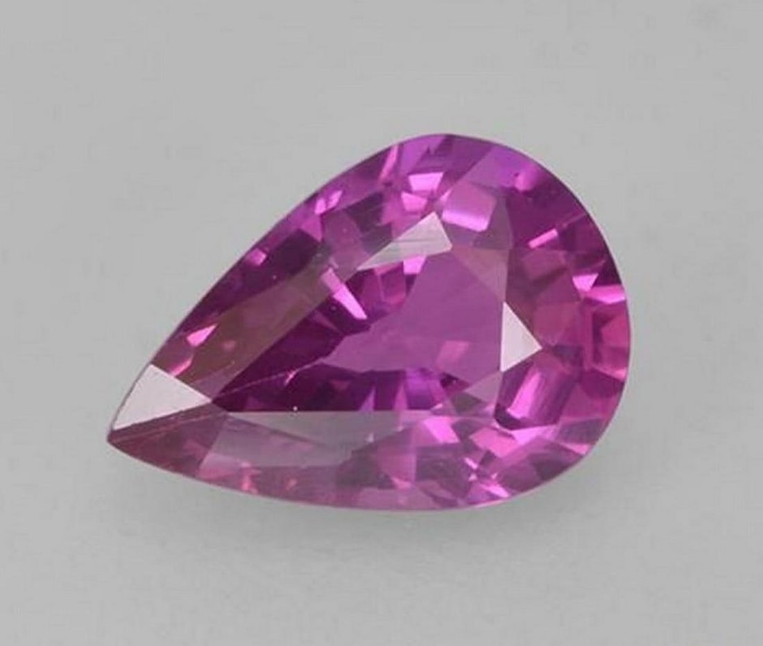 0.66 ct Natural Deep Pinkish Purple Sapphire - Pear Facet: 0.66 ct Natural Deep Pinkish Purple Sapphire - Pear Facet Introducing the Natural Deep Pinkish Purple Sapphire, a captivating gemstone that combines elegance and brilliance in a pear facet shape. Its