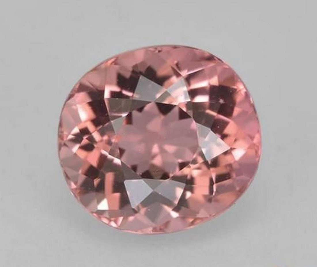 1.53 ct Natural Light Pink Tourmaline - Oval Facet: 1.53 ct Natural Light Pink Tourmaline - Oval Facet Introducing the Natural Light Pink Tourmaline, a delicate gemstone featuring a soft, enchanting pink hue. Cut in an oval facet shape, this gem