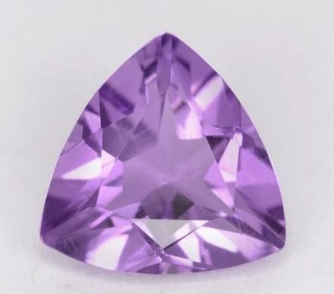 Loose Trillion-Cut Amethyst: Loose Trillion-Cut Amethyst Showcasing a vibrant violet hue, this loose amethyst gemstone is expertly cut in a stunning trillion facet shape. With its sharp angles and dazzling brilliance, the