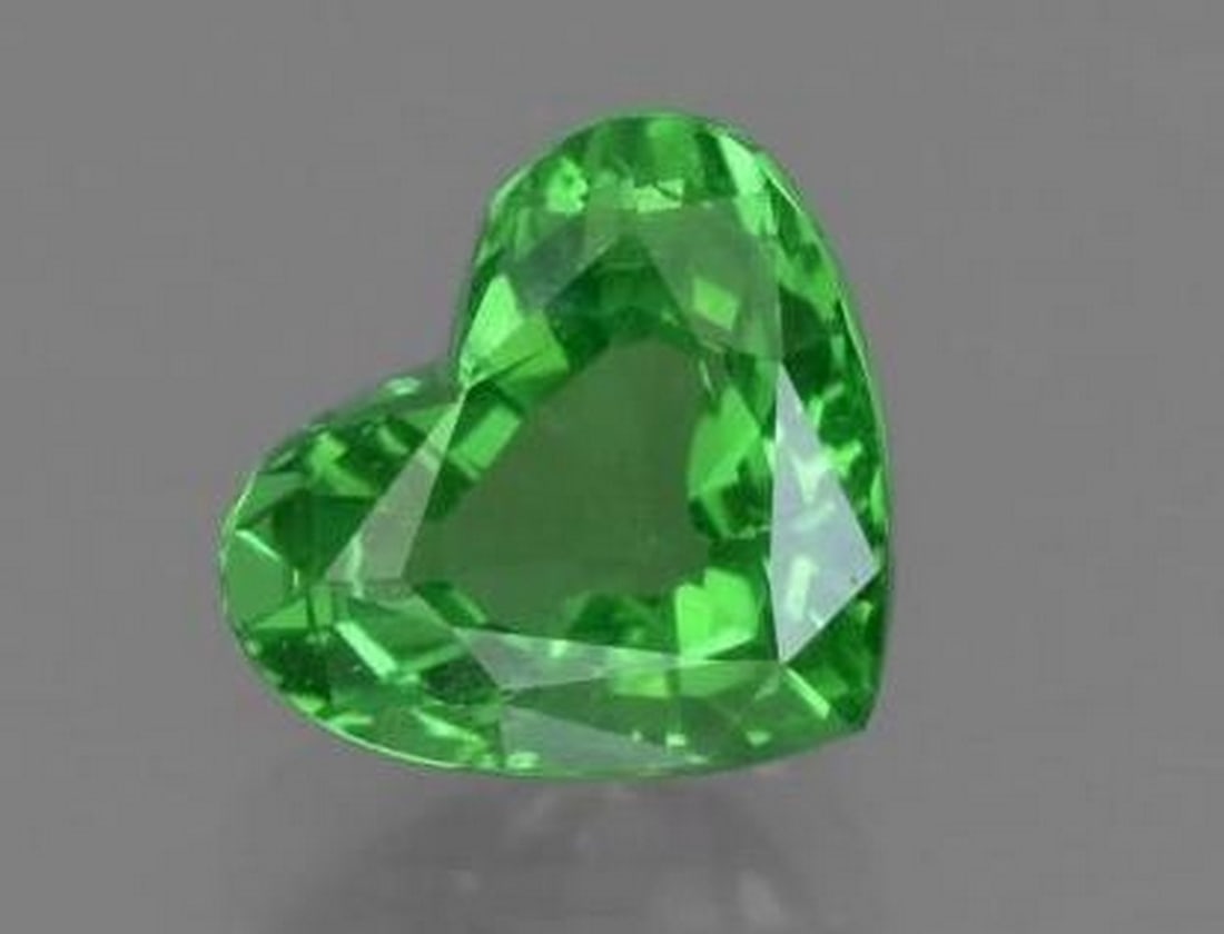 Medium Green Tsavorite Garnet Heart Faceted Gemstone: Medium Green Tsavorite Garnet Heart Faceted Gemstone Full of vibrant charm, this heart-shaped Tsavorite Garnet sparkles in a refreshing medium green hue. The precision faceting enhances its