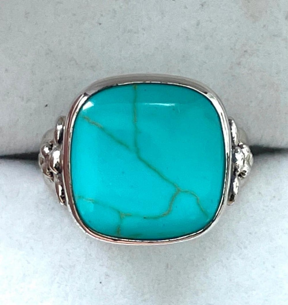 Large Turquoise Gemstone Ring Set on a 925 Sterling Silver Band: Large Turquoise Gemstone Ring Set on a 925 Sterling Silver Band. Turquoise is a stone that is associated with ancient, godlike power according to mythology. It is said to be lucky, promoting financial