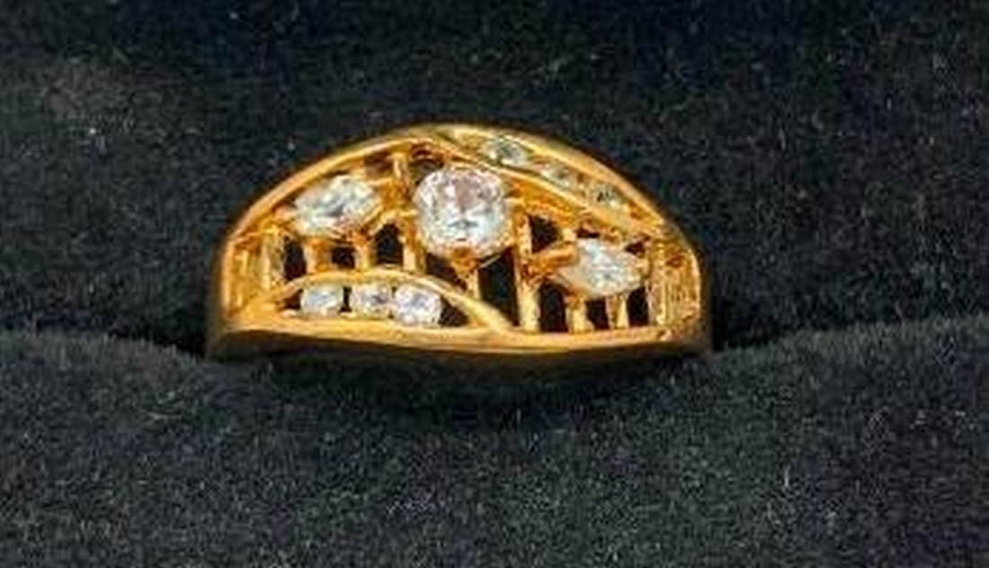 Ladder Design Ring with Mixed-Cut White Stones: Ladder Design Ring with Mixed-Cut White Stones Modern elegance meets artistic flair in this unique 18KT gold plated electroplated ring, featuring a striking ladder-style band. Set between the open gol
