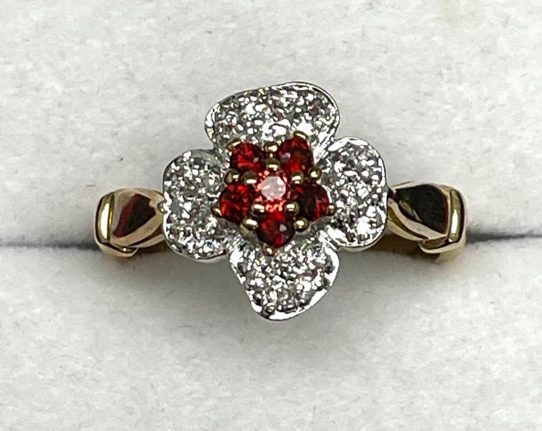 Band with 5 Small Rubies Positioned in the Shape of a Flower: Band with 5 Small Rubies Positioned in the Shape of a Flower Surrounded by Inlaid Swarovski Crystals. Rubies are associated with heart health and healing of other bodily aliments. They are also said