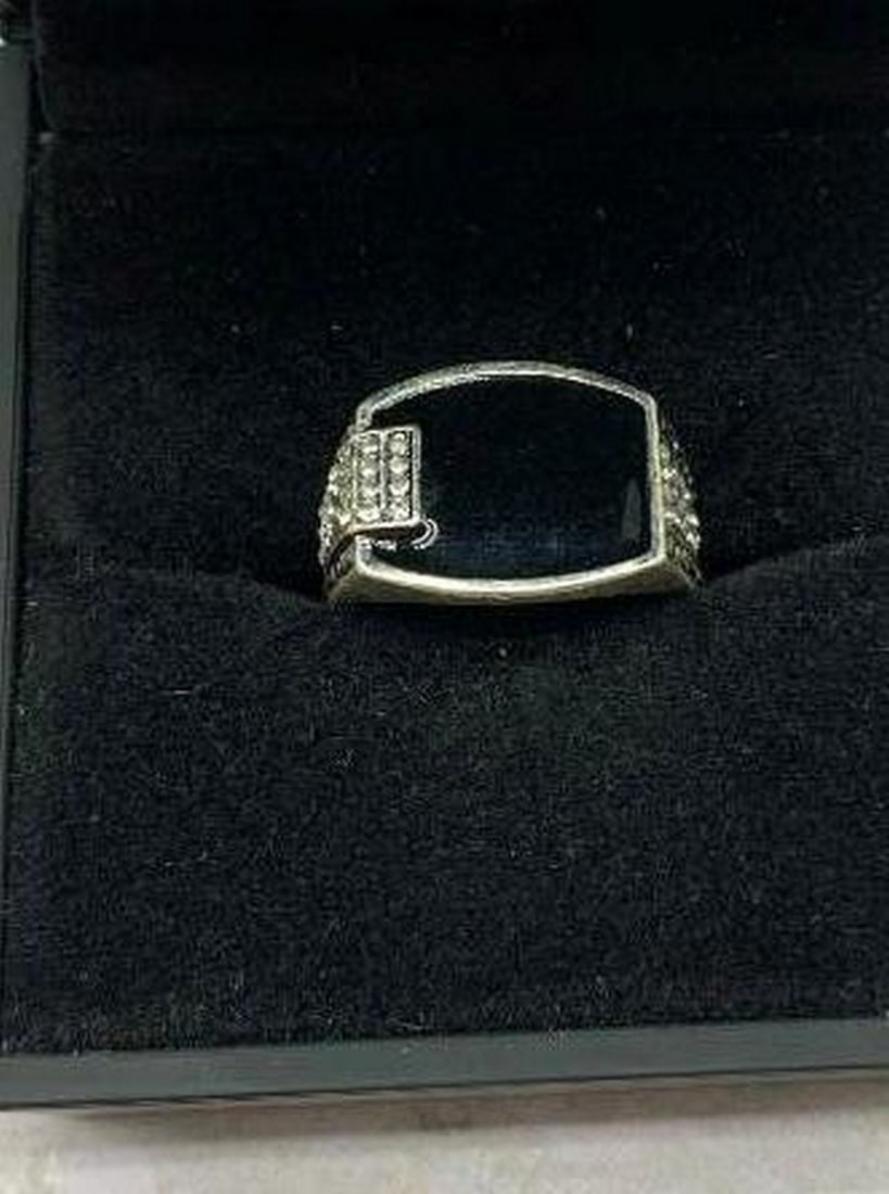 Sterling Silver Ring with Black Square Stone and White Gem Accents: Sterling Silver Ring with Black Square Stone and White Gem Accents Striking in contrast and design, this sterling silver ring showcases a bold square-cut black stone as its centerpiece, framed by spar