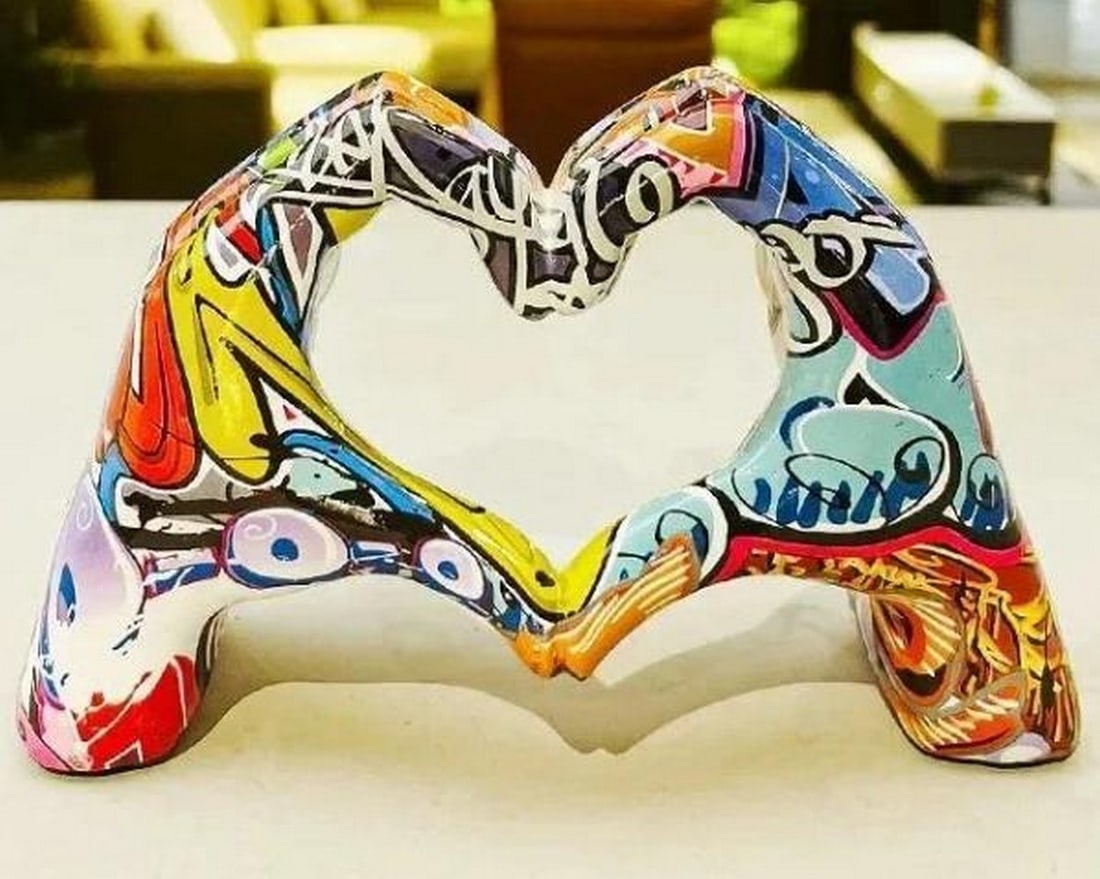 Graffiti Heart Hands Sculpture: Graffiti Heart Hands Sculpture A powerful symbol of love with a rebellious twist, this vibrant sculpture features two hands forming a heart, entirely wrapped in dynamic graffiti art. Bursting with