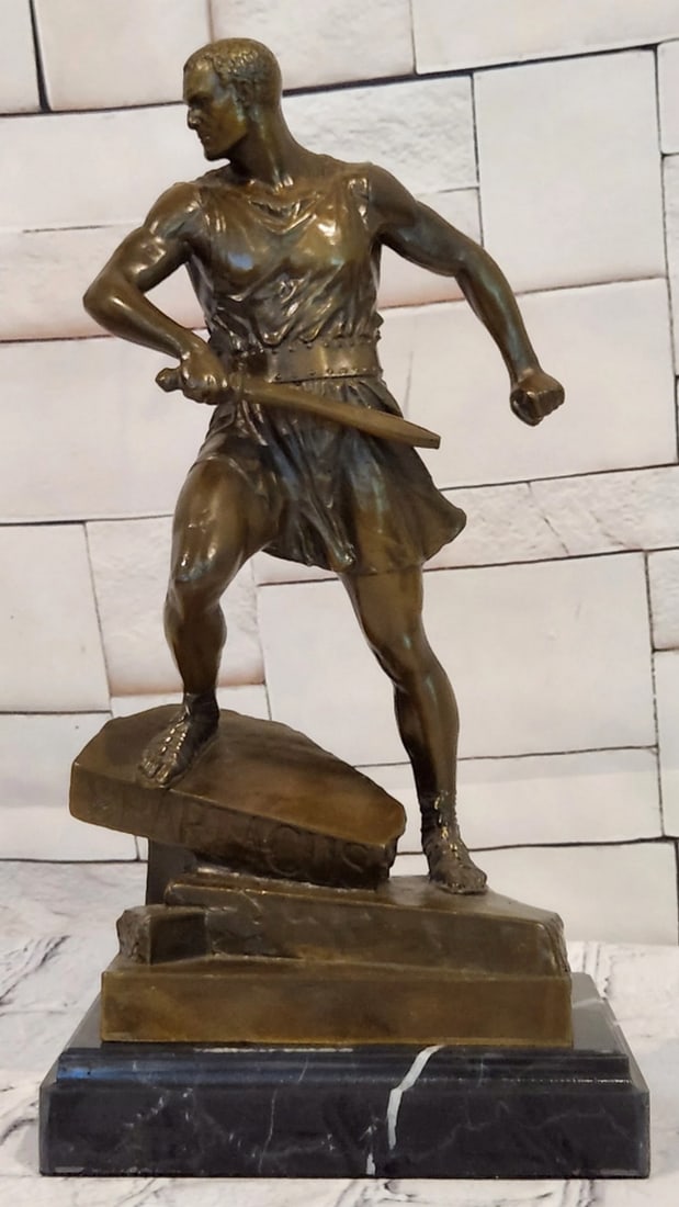 Roman Warrior Bronze Sculpture by J. Mavchi - 12" x 6": Roman Warrior Bronze Sculpture by J. Mavchi - 12" x 6" Introducing a Bronze Sculpture: This depiction of a Roman warrior is handcrafted with attention to detail. The figure is shown in a poise