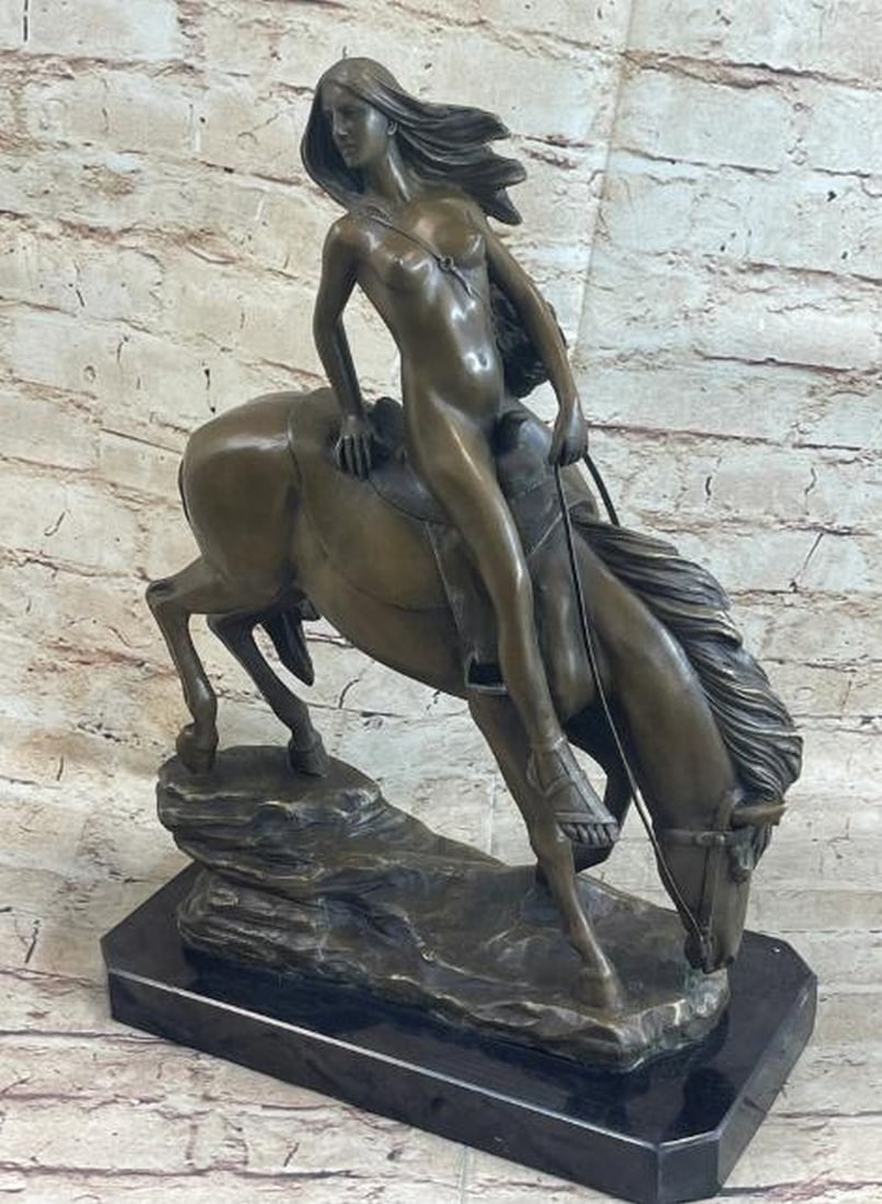 Grace in Motion: Nude Girl on Horseback Bronze Sculpture: Grace in Motion: Nude Girl on Horseback Bronze Sculpture Elegant and evocative, this reproduction bronze sculpture features a nude young woman seated gracefully atop a majestic horse. The rider's form
