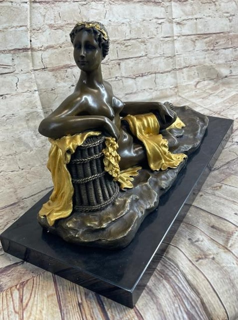 Lounging Nude Goddess Bronze Sculpture: Lounging Nude Goddess Bronze Sculpture A refined reproduction in the classical tradition, this bronze sculpture captures the serene beauty of a reclining nude female figure, inspired by ancient Greek 