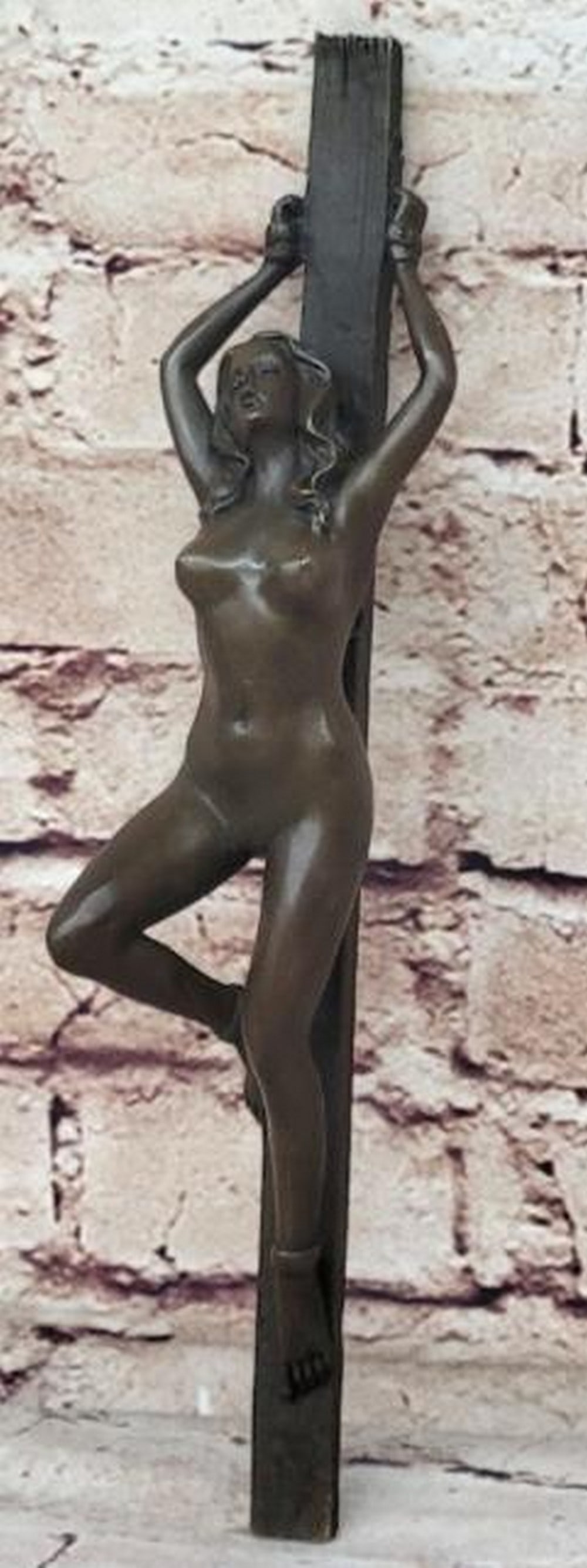 Bound Grace Bronze Sculpture: Bound Grace Bronze Sculpture A striking and emotive bronze sculpture depicting a nude woman bound to a wooden pole, her arms raised above her head and legs restrained, with her head lifted in a powerf