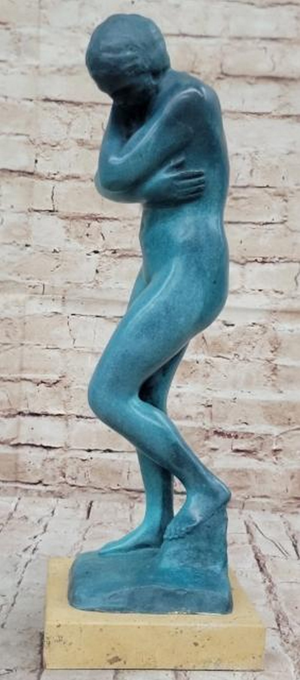 Blue Patina Nude Reproduction Bronze Sculpture: Blue Patina Nude Reproduction Bronze Sculpture This evocative reproduction bronze sculpture, bearing the signature of renowned artist Auguste Rodin, captures a moment of quiet vulnerability and intros
