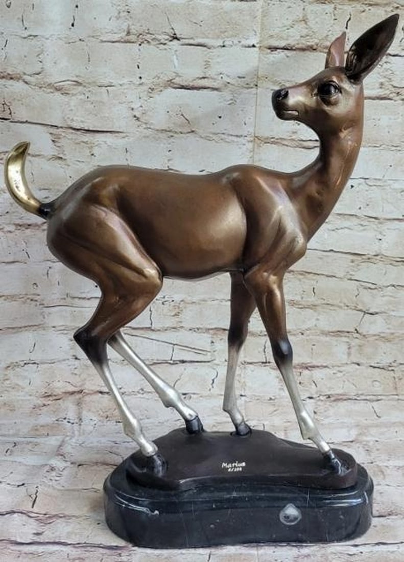 Bronze Doe with Patina Highlights: Bronze Doe with Patina Highlights Elegant and serene, this bronze reproduction, bearing the signature of artist Marius, captures the gentle presence of a standing doe, brought to life with artistic pa