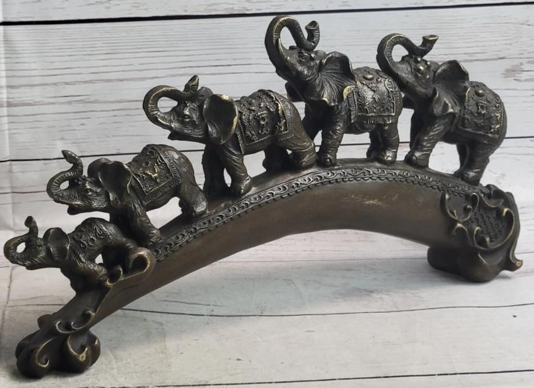 Triumphant Crossing Elephants on the Bridge Bronze Sculpture: Triumphant Crossing Elephants on the Bridge Bronze Sculpture A celebration of joy, strength, and good fortune, this bronze metal sculpture, bearing the signature of renowned artist Miguel Lopez, featu