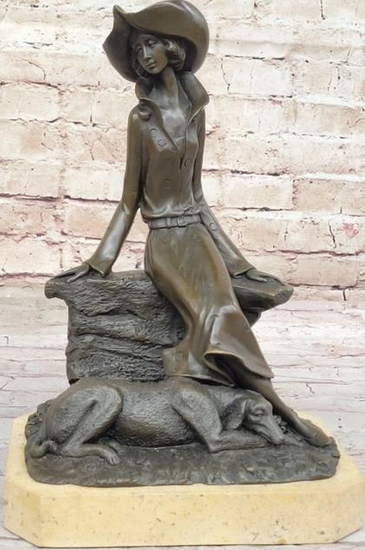 Bronze Lady and Dog on Rock Wall: Bronze Lady and Dog on Rock Wall This graceful bronze sculpture, bearing the signature of renowned artist Milo, captures a serene moment of quiet companionship. A refined lady seated elegantly on a ro