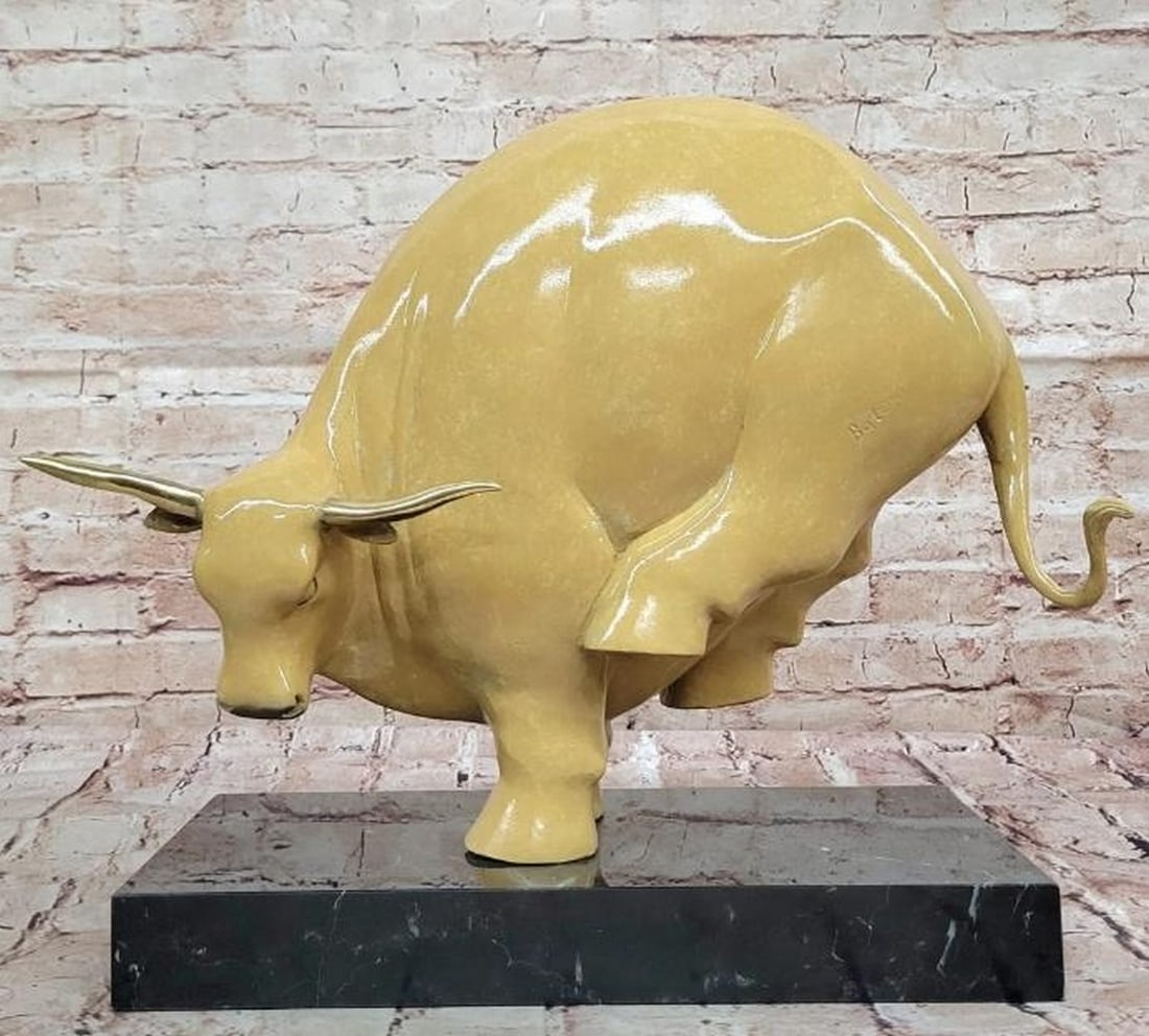 Abstract Kicking Bull in Beige Patina: Abstract Kicking Bull in Beige Patina Dynamic and full of motion, this abstract bronze sculpture captures a bull mid-kick, its powerful hind legs arched beneath it and head turned sharply to the side.