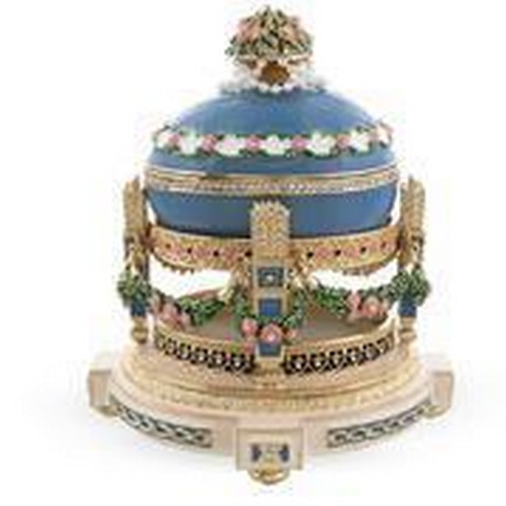1907 Love Trophies Egg (Cradle with Garlands) Musical Royal Faberge Inspired Egg: 1907 Love Trophies Egg (Cradle with Garlands) Musical Royal Faberge Inspired Egg 5.8 Inches Tall (on a stand) x 5.3 Inches Wide 14.732 cm Tall (on a stand) x 13.462 cm Wide Enameled Gold Plate