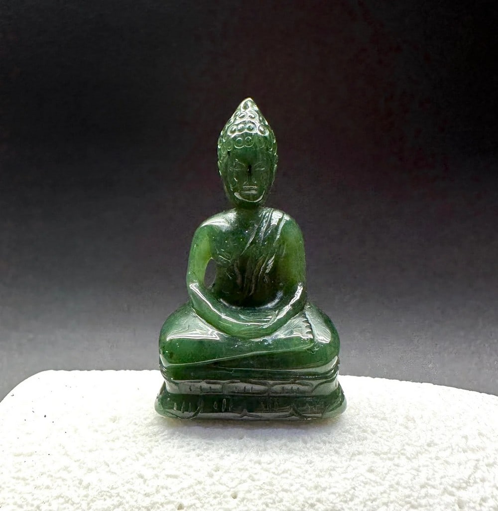 Canadian Nephrite Buddha Jade Carving: Canadian Nephrite Buddha Jade Carving Crafted from deep green Canadian nephrite jade, this serene Buddha carving embodies peace, enlightenment, and inner harmony. With a tranquil expression and gracef