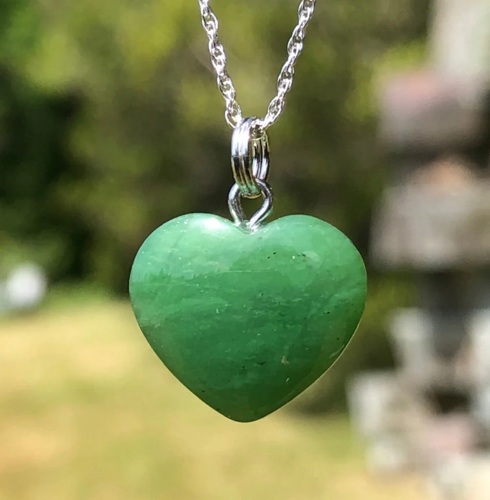 Canadian Nephrite Jade Heart Pendant: Canadian Nephrite Jade Heart Pendant This pendant is hand-carved from genuine Canadian Nephrite Jade, featuring a refined heart-shaped design that embodies love and harmony. The polished surface enhan
