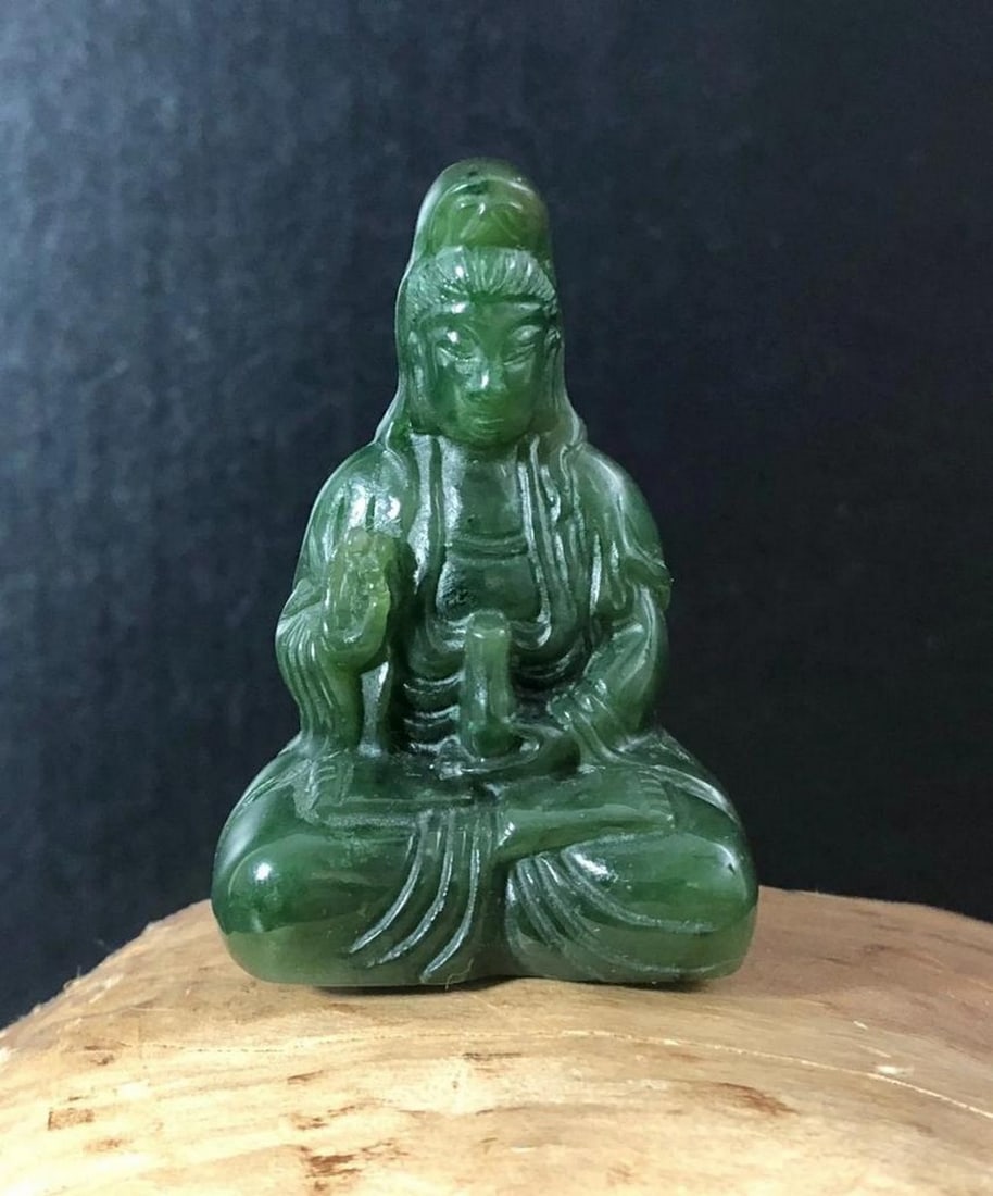 Guanyin Carving - Canadian Nephrite Jade: Guanyin Carving - Canadian Nephrite Jade Finely crafted Guanyin figurine carved from Canadian nephrite jade with a high polish finish. Symbolizing compassion and serenity, this piece carries natural v