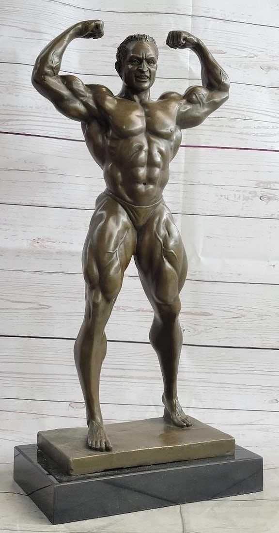 Original Signed Kauba Strong Bodybuilder Bronze Sculpture - 20" x 9": Original Signed Kauba Strong Bodybuilder Bronze Sculpture - 20" x 9" Bronze Iron Man Statue. An Intricately Crafted Piece Is Of A Strong Man Confidently Placing Is Hands On Hips. Each Curvatur