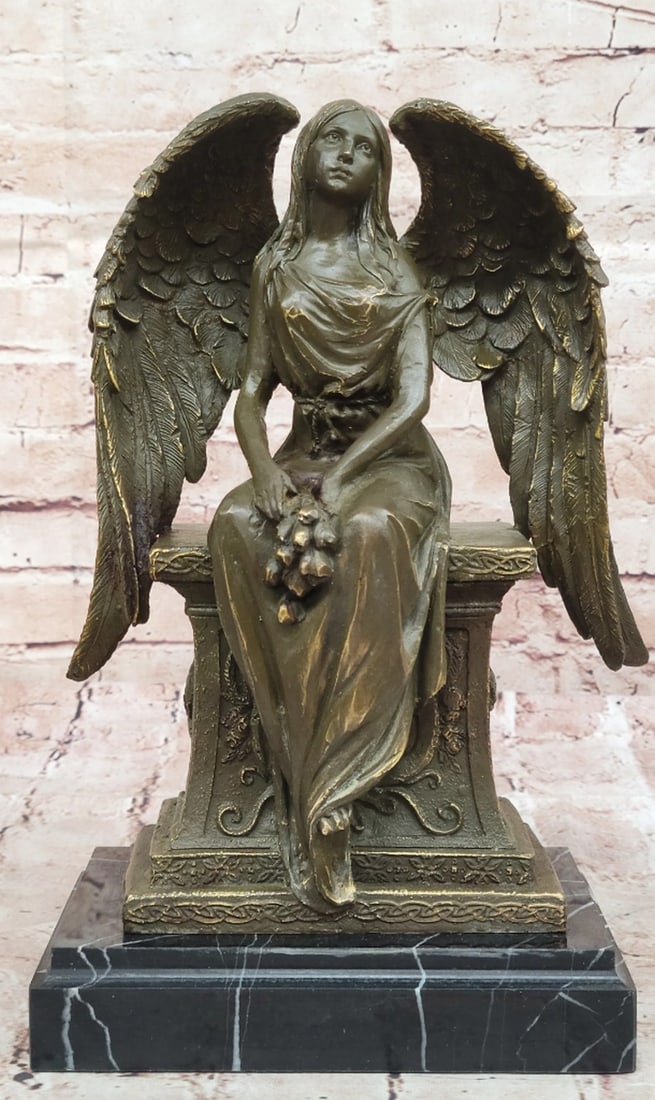 Seated Angel Holding Flowers Inspired Bronze Statue - 11.5" x 8": Seated Angel Holding Flowers Inspired Bronze Statue - 11.5" x 8" This graceful bronze sculpture of a Guardian Angel radiates serenity and protection, tenderly holding a delicate flower as a sy