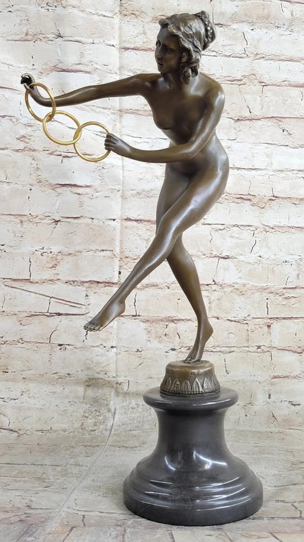 Colinet Inspired Dancing Acrobat Bronze Sculpture - 16.5" x 11": Colinet Inspired Dancing Acrobat Bronze Sculpture - 16.5" x 11" The bronze nude acrobat steps forward showcasing her agility as she plays with three gold interlocked rings. This sculpture has 
