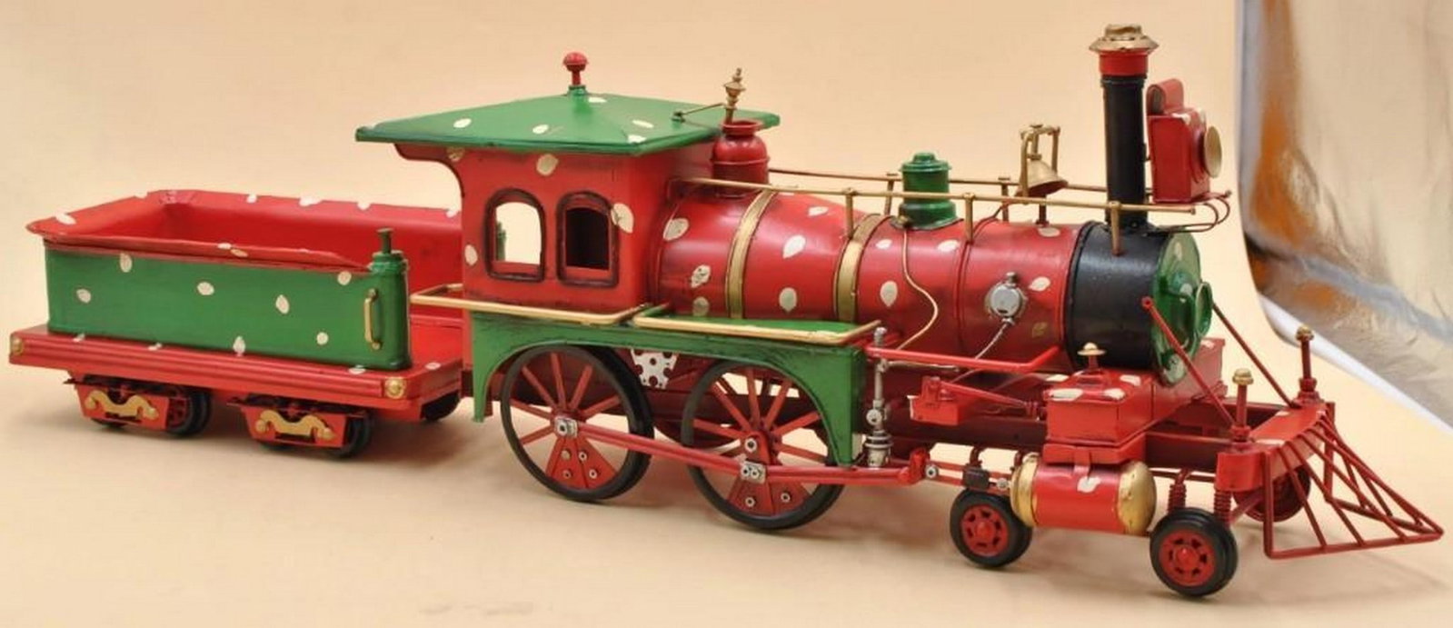 1906 Tin Model Steam Train in Red & Green: 1906 Tin Model Steam Train in Red & Green This beautifully crafted handmade reproduction of a 1906 steam train captures the elegance and grandeur of early 20th-century locomotives. Made from durable p