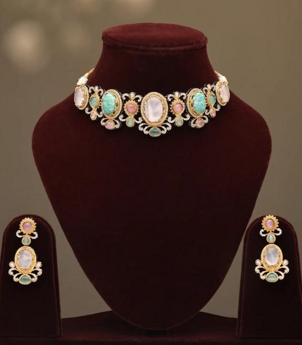 Radiant Allure: Radiant Allure Stone-Studded Choker Set with Earrings Discover a piece that whispers tales of refined luxury and artisanal craftsmanship. This exquisite choker set, adorned with a captivating array