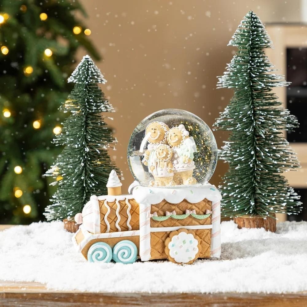 Gingerbread Family Christmas Musical Snow Globe: Gingerbread Family Christmas Musical Snow Globe Bring festive charm to your holiday decor with this 100mm Christmas Resin Musical Snowflakes Waterglobe. Featuring a delightful gingerbread family