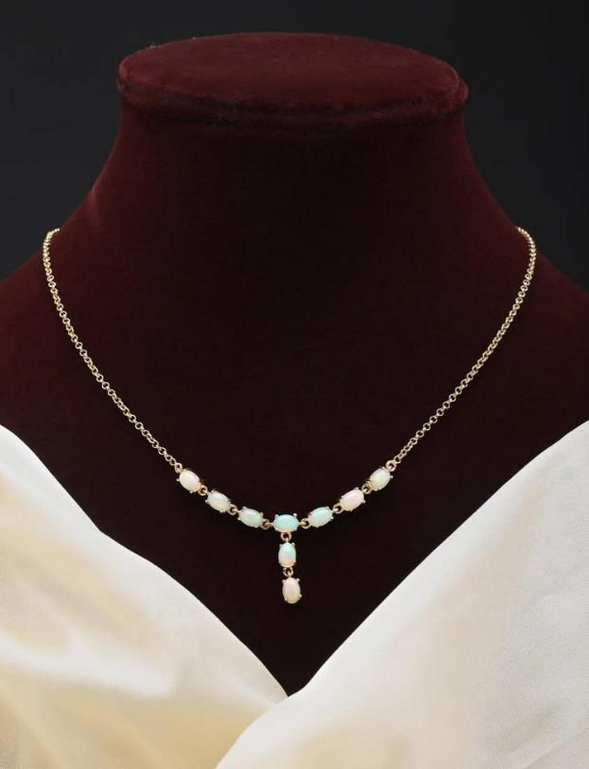 Radiant Flow: Radiant Flow - Oval Cut Ethiopian Opal Drop Necklace Discover a piece that captures the ethereal beauty of the cosmos, a necklace that whispers tales of ancient light and celestial wonder. This