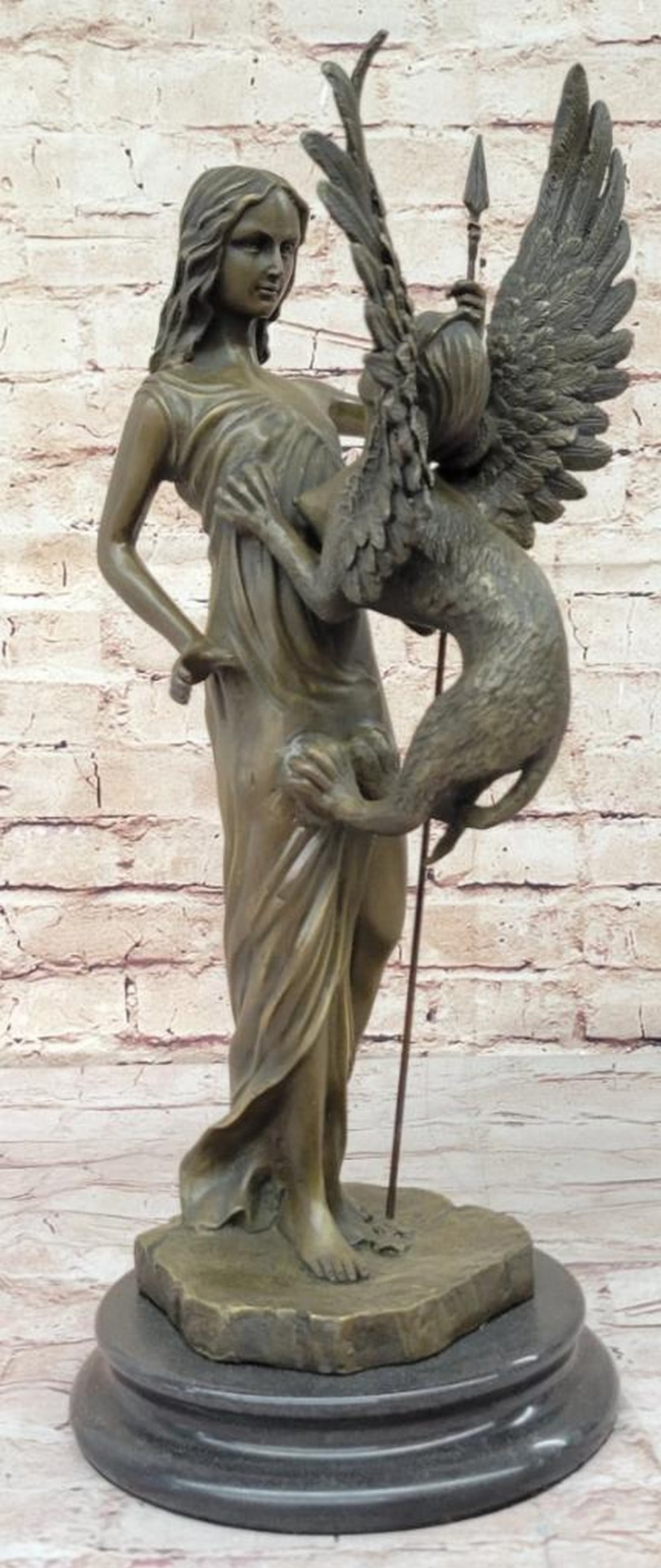 Inspired Signed Bronze Sculpture of Woman Confronting Griffin by M. Mercie - 18" x 9": Inspired Signed Bronze Sculpture of Woman Confronting Griffin by M. Mercie - 18" x 9" Step into a mesmerizing encounter of myth and reality with our captivating bronze sculpture. Here, a fearl