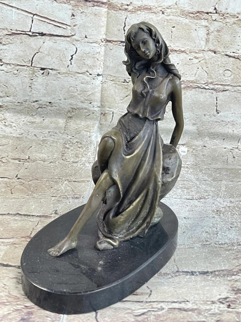 Young Girl Resting Against Rock Original Bronze Statue - 8" x 6": Young Girl Resting Against Rock Original Bronze Statue - 8" x 6" This exquisite bronze sculpture captures grace and strength in one. The figure's alluring form drapes over a rock, merging with