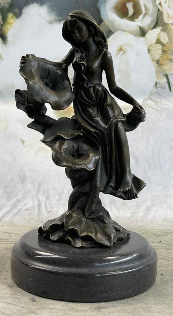 Girl Resting on Flower Bronze Statue: Girl Resting on Flower Bronze Statue Get lost in a daydream. She leans back on a tree stump and flowers grow all around her. She stretches an arm out to feel the blossom graze her skin. She is one wit