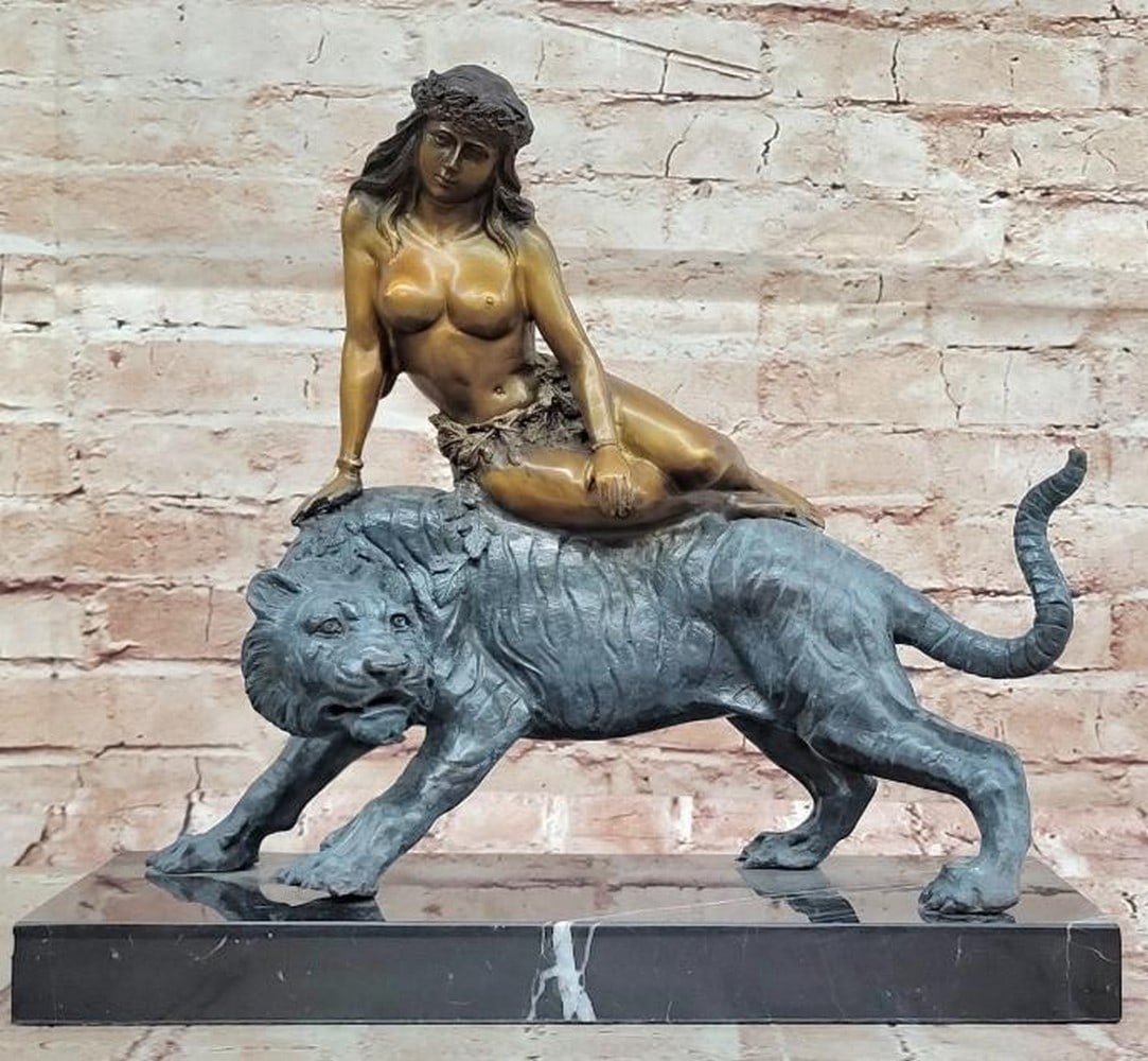 Bronze Jungle Girl Reclining on Tiger Sculpture: Bronze Jungle Girl Reclining on Tiger Sculpture This striking Bronze Jungle Girl Reclining on Tiger Sculpture, inspired by the renowned artist and bearing the signature of Aldo Vitaleh, elegantly