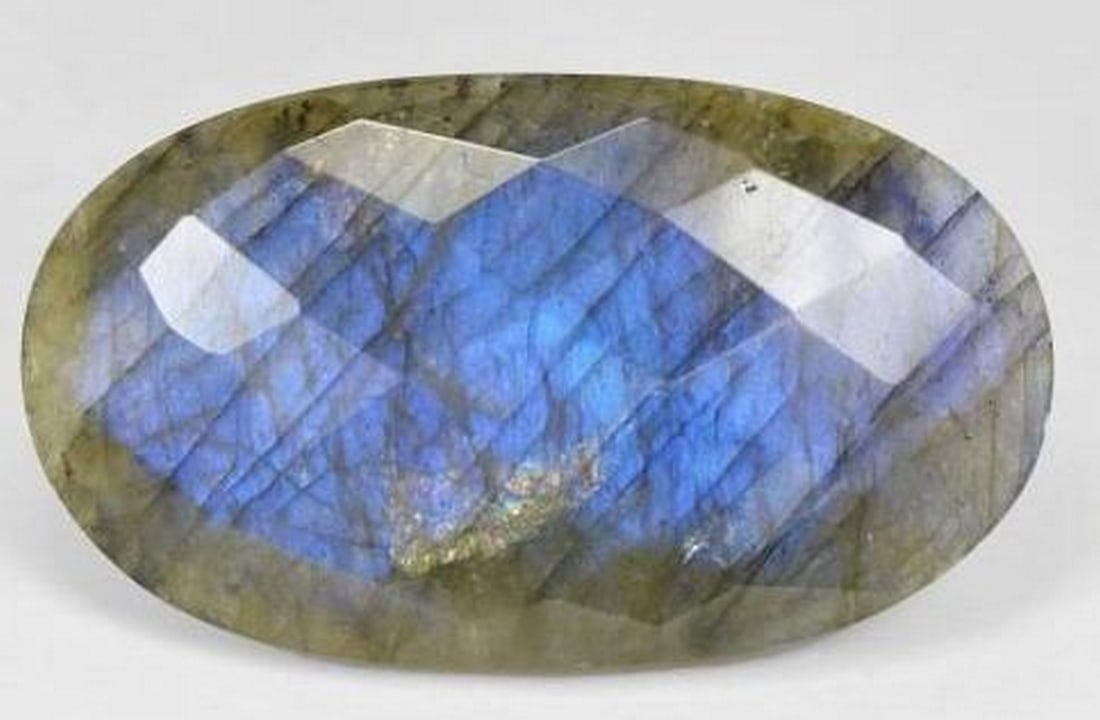 Loose Labradorite Gemstone Multicolor Oval Checkerboard Cut: Loose Labradorite Gemstone Multicolor Oval Checkerboard Cut Mystical and mesmerizing, this loose Labradorite gemstone features a unique oval checkerboard cut that enhances its natural play of color. F