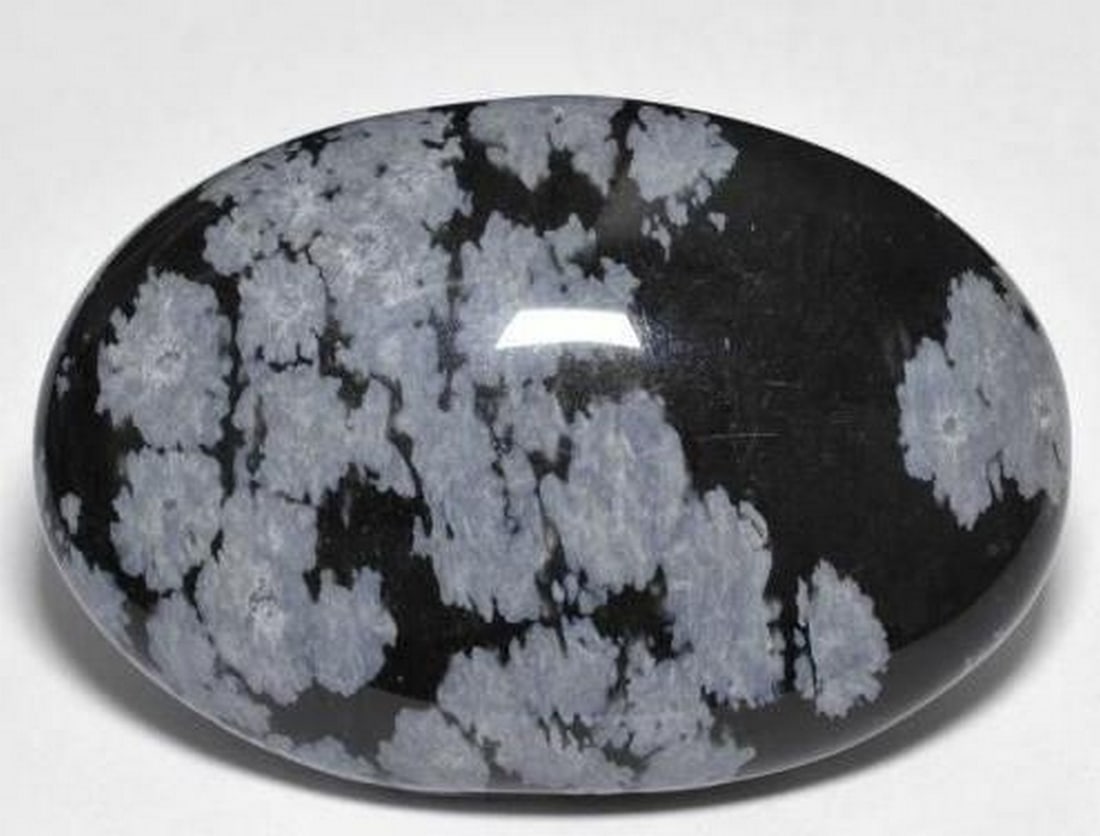 Gray-White and Black Snowflake Obsidian Oval Cabochon Gemstone: Gray-White and Black Snowflake Obsidian Oval Cabochon Gemstone This striking loose gemstone is an oval cabochon of Snowflake Obsidian, showcasing a beautiful blend of gray, white, and black tones.