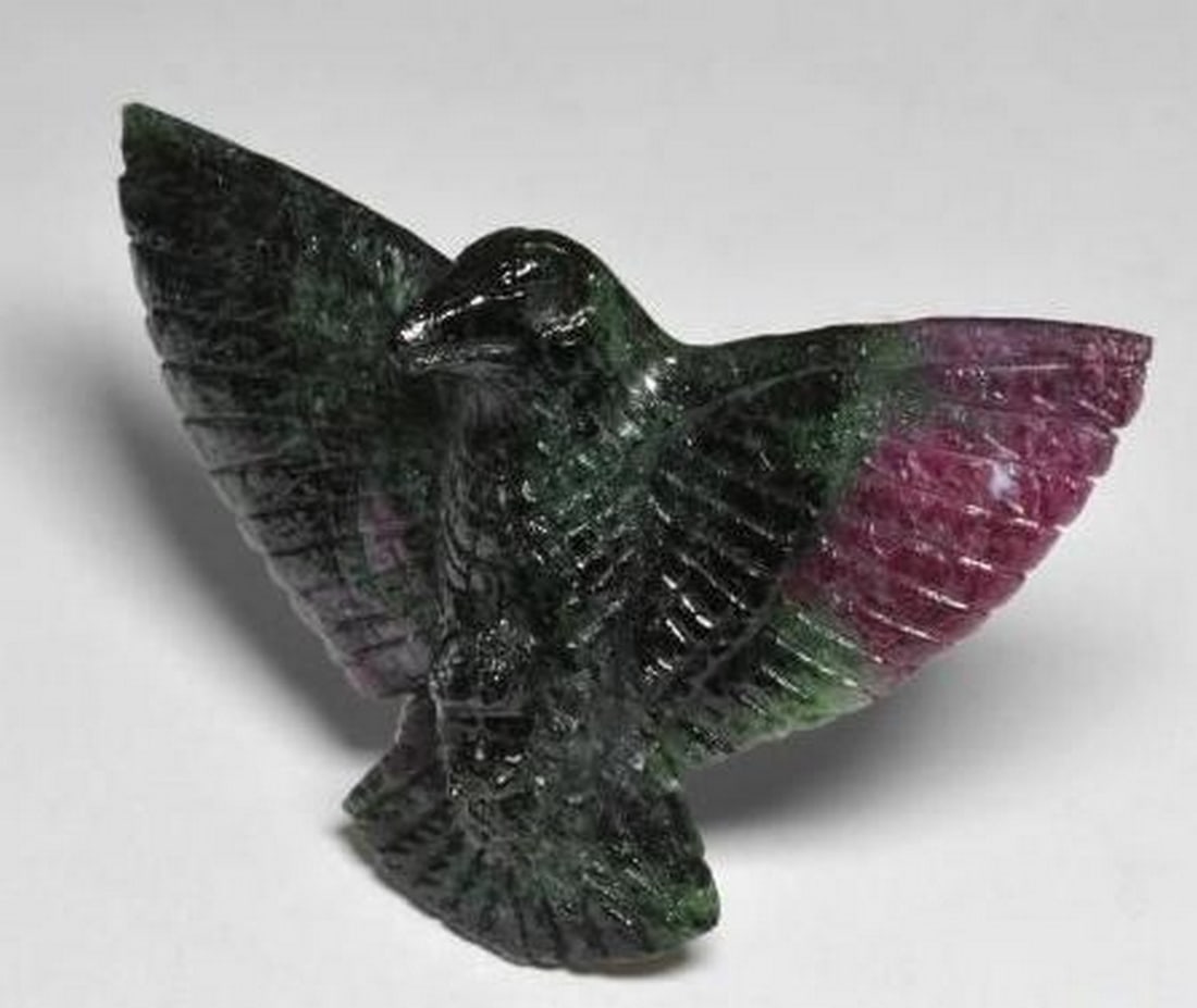 Multicolor Ruby-Zoisite Gemstone Carved Bird: Multicolor Ruby-Zoisite Gemstone Carved Bird Expertly carved from natural Ruby-Zoisite, this loose gemstone takes the graceful form of a bird in mid-perch. A vivid blend of deep black, rich ruby red,