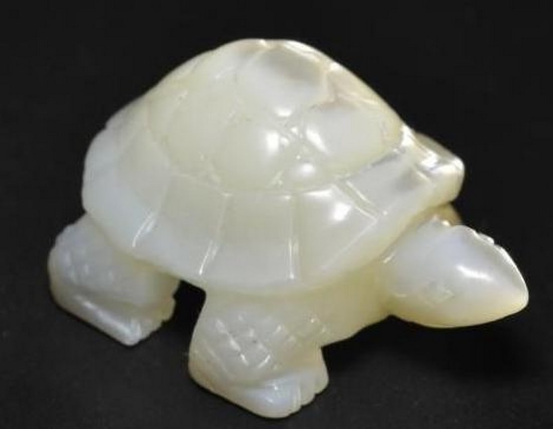 Loose Mother of Pearl Gemstone Hand-Carved Turtle in Pearl White: Loose Mother of Pearl Gemstone Hand-Carved Turtle in Pearl White Delicate and symbolic, this loose Mother of Pearl gemstone is skillfully carved into the shape of a turtle, radiating a soft, luminous 