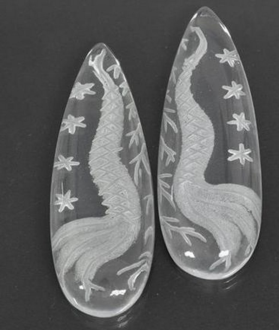 Set of Two Clear White Quartz Pear Gemstones: Set of Two Clear White Quartz Pear Gemstones This whimsical set includes two loose gemstones carved from clear white quartz, each shaped into an elegant pear. At the surface of each gem, a detailed de