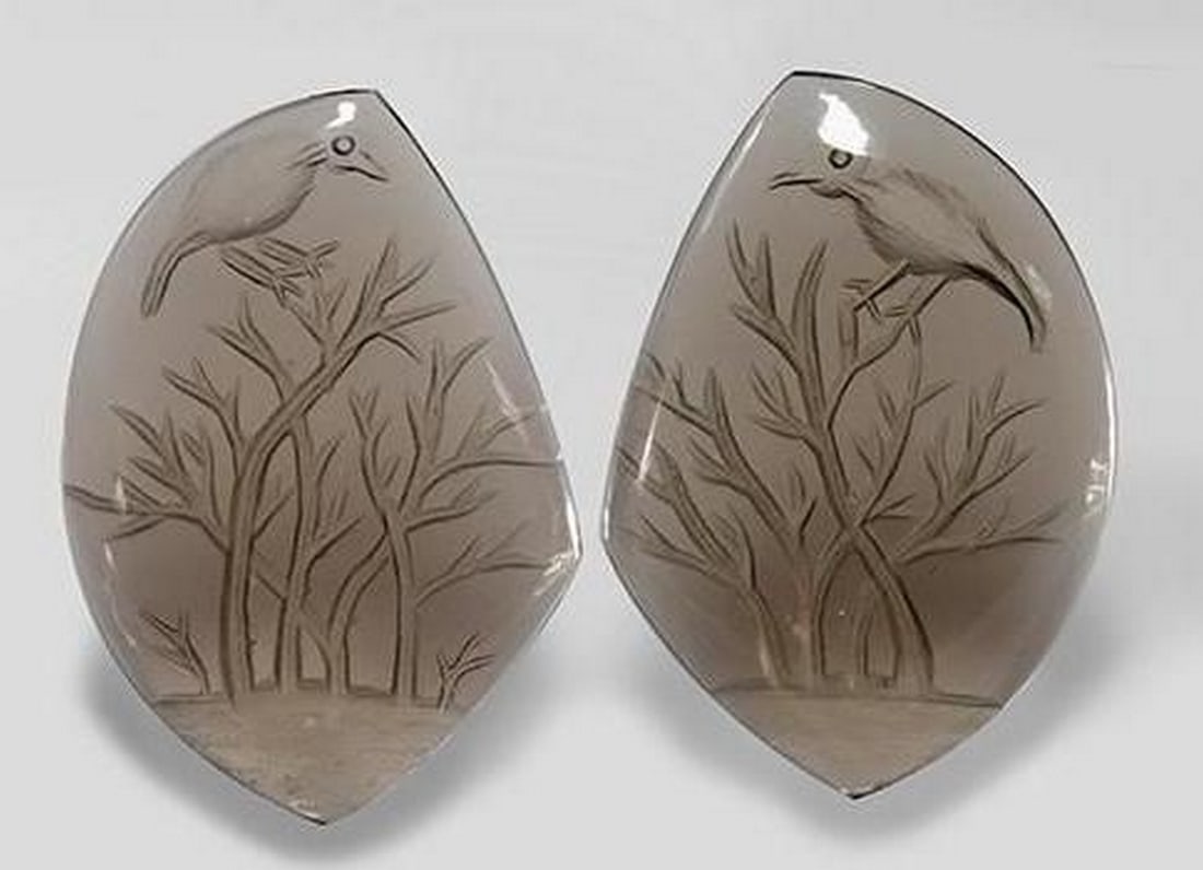 Set of Two Smoky Quartz Gemstones with Tree and Bird Carvings: Set of Two Smoky Quartz Gemstones with Tree and Bird Carvings This unique set features two loose gemstones made from light wood brown smoky quartz, each intricately carved with a serene scene of a tre