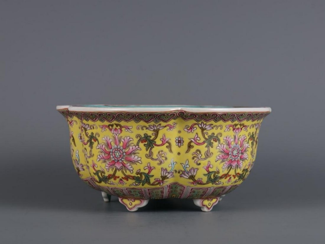 Inspired Qianlong Yellow Ground Famille Rose Flower Pot: Inspired Qianlong Yellow Ground Famille Rose Flower Pot This inspired flower pot from the Qianlong period of the Qing Dynasty features a vibrant yellow ground adorned with intricate famille rose flora