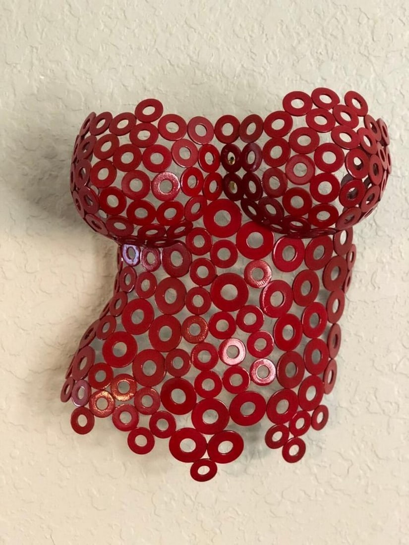 Red Lady Steel Metal Sculpture: Red Lady Steel Metal Sculpture This elegantly crafted female torso sculpture showcases the beauty of form and movement, hand-formed and welded with precision. The interplay of metalwork and sculptural