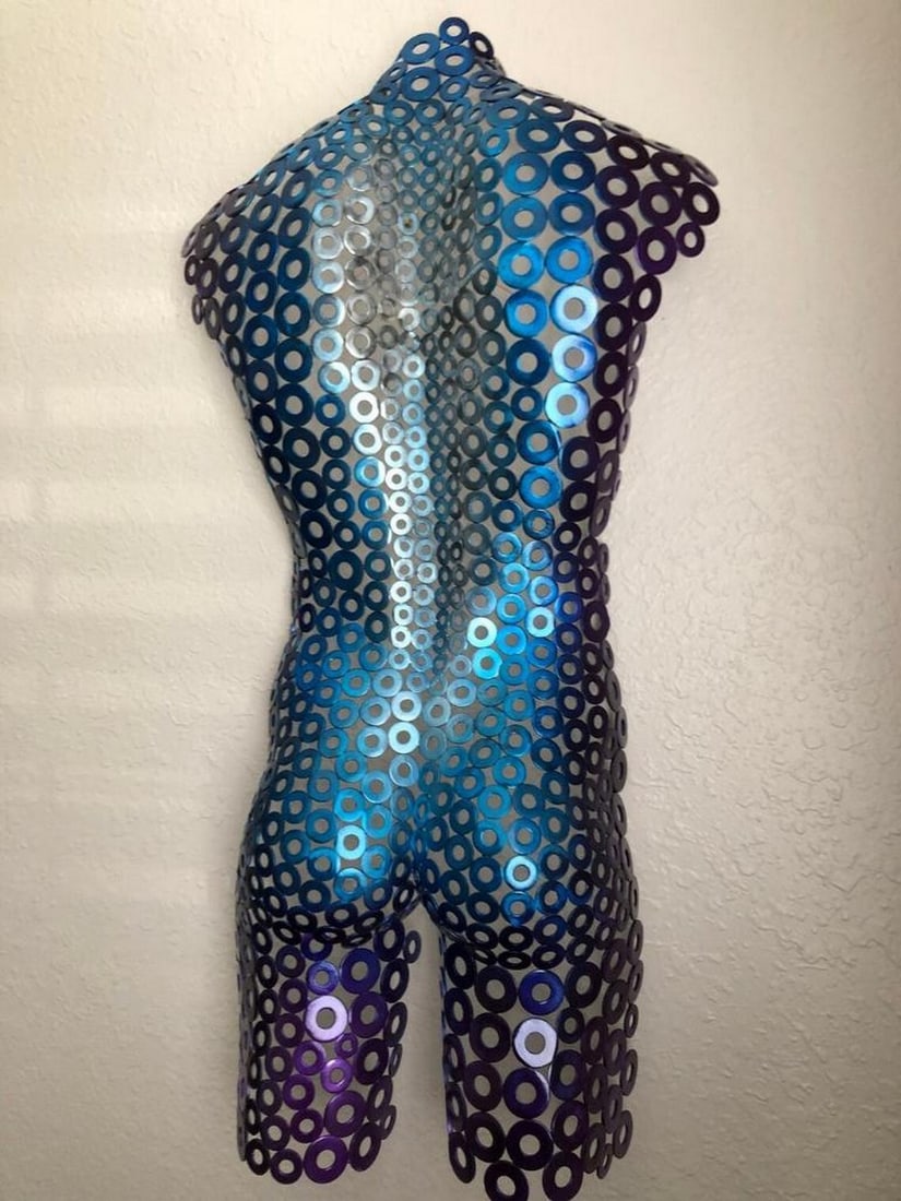 Eclipse in Blue Male Torso Metal Sculpture: Eclipse in Blue Male Torso Metal Sculpture This powerful male torso sculpture embodies strength and movement, meticulously hand-formed and welded. The interplay of blue, purple, and natural silver cre