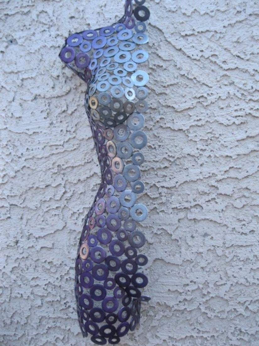 Cassidy Metal Sculpture: Cassidy Metal Sculpture This striking female half torso sculpture is a testament to the artistry and craftsmanship of hand-formed metal. Created by the artist, each piece is unique and designed to com